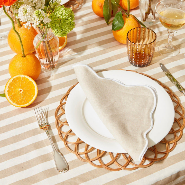 Beige scallop linen napkins styled on a laid table