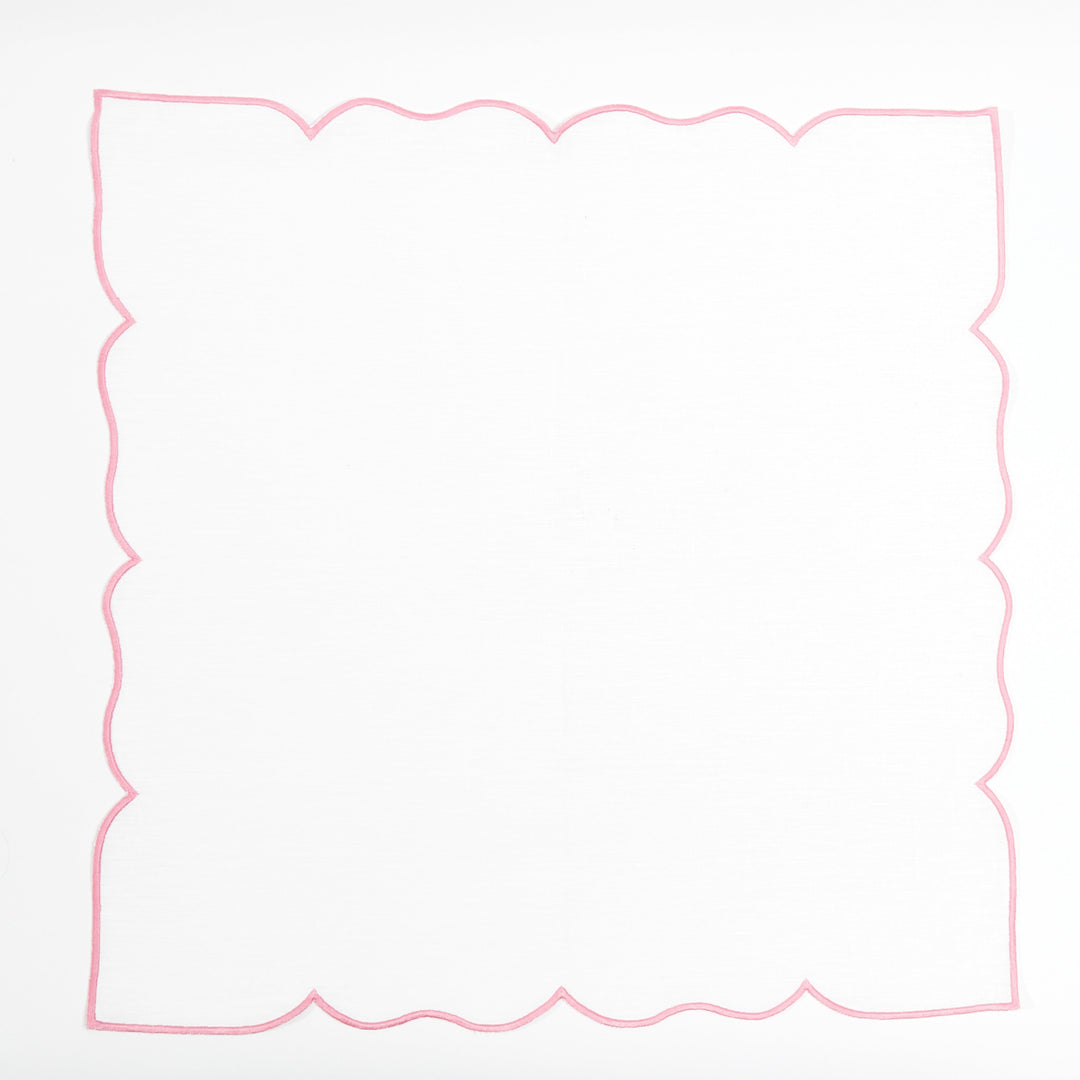 Pink Ava linen napkin paired with rattan placemat