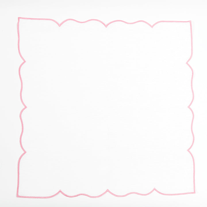 Pink Ava linen napkin paired with rattan placemat