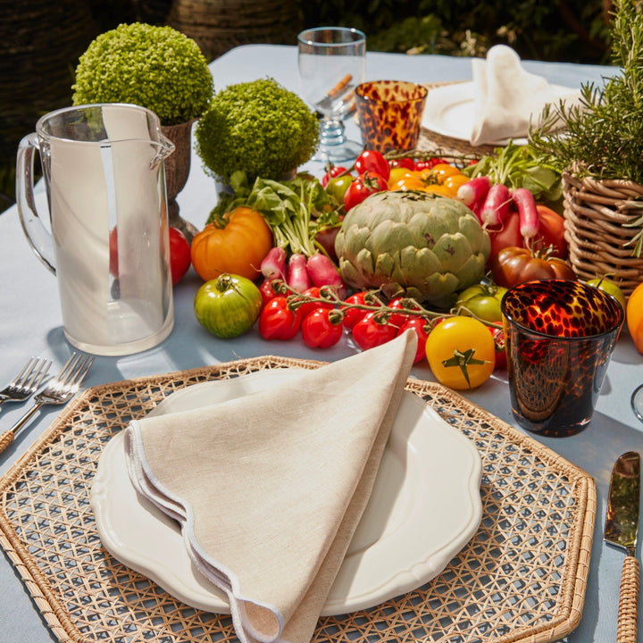 Beige scallop napkin showing white embroidered edge detail