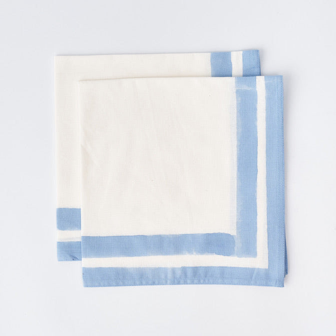 Provence Blue Edged Napkin folded, showing hand-printed blue edge detail