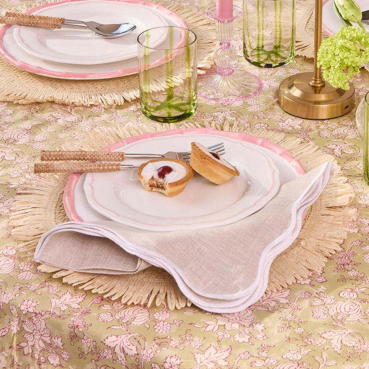 Beige scallop linen napkin detail against neutral tableware