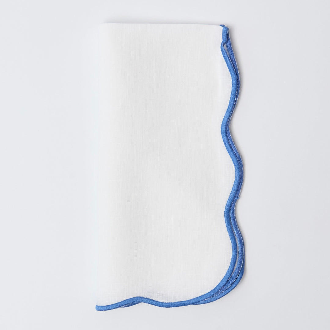 Blue edged linen napkins styled on a laid table