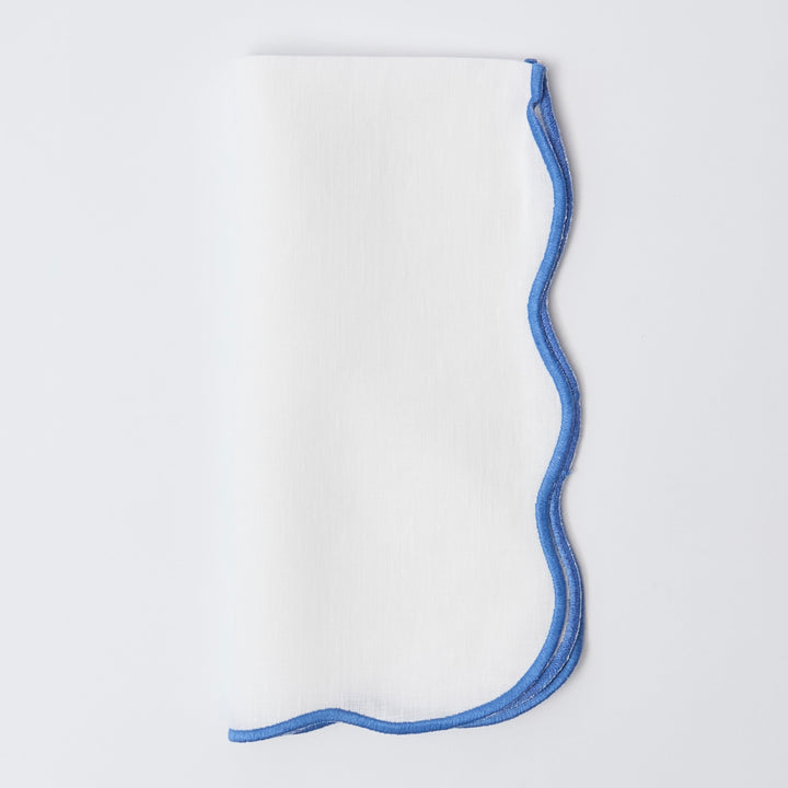 Blue edged linen napkins styled on a laid table