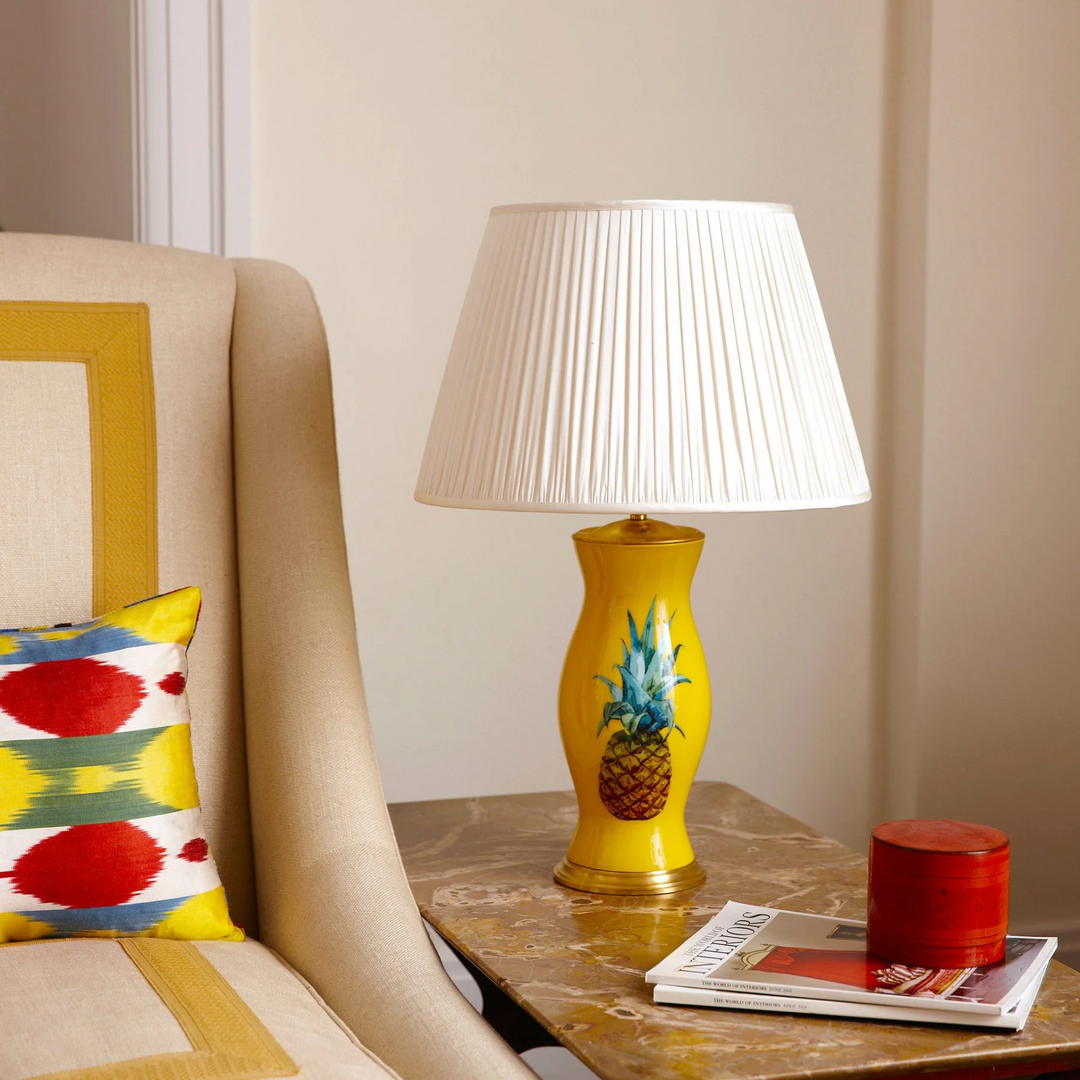Yellow table lamp with pineapple pattern, adding a tropical touch to any room decor.