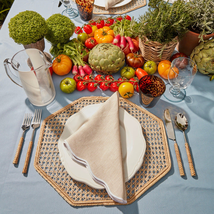 Beige scallop linen napkin folded on a place setting