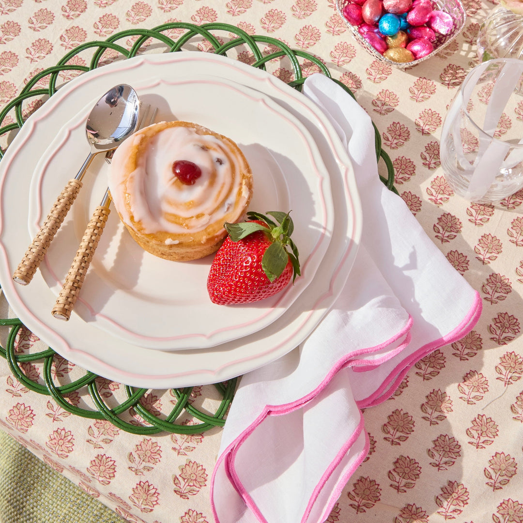 Pink Ava linen napkins styled on a summer table