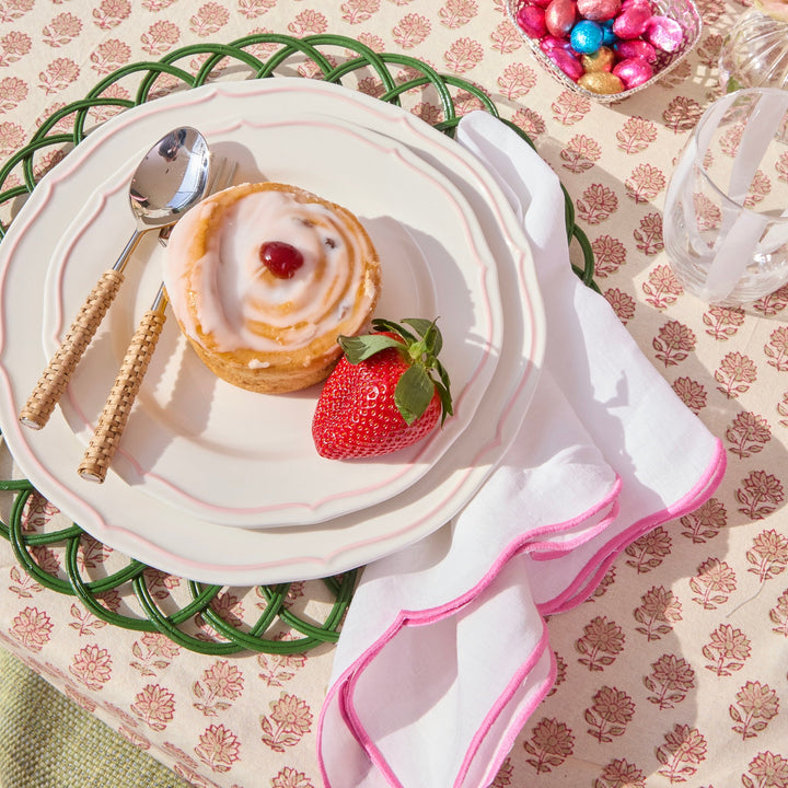 Pink Ava linen napkins styled on a summer table