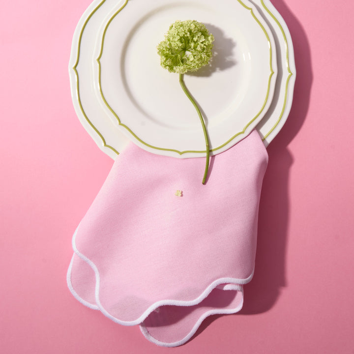 Pale pink wave napkin showing white embroidered edge detail