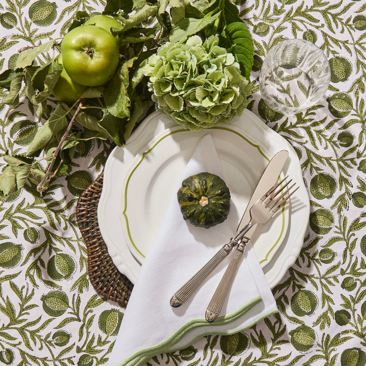 Green scallop linen napkin showing embroidered edge detail