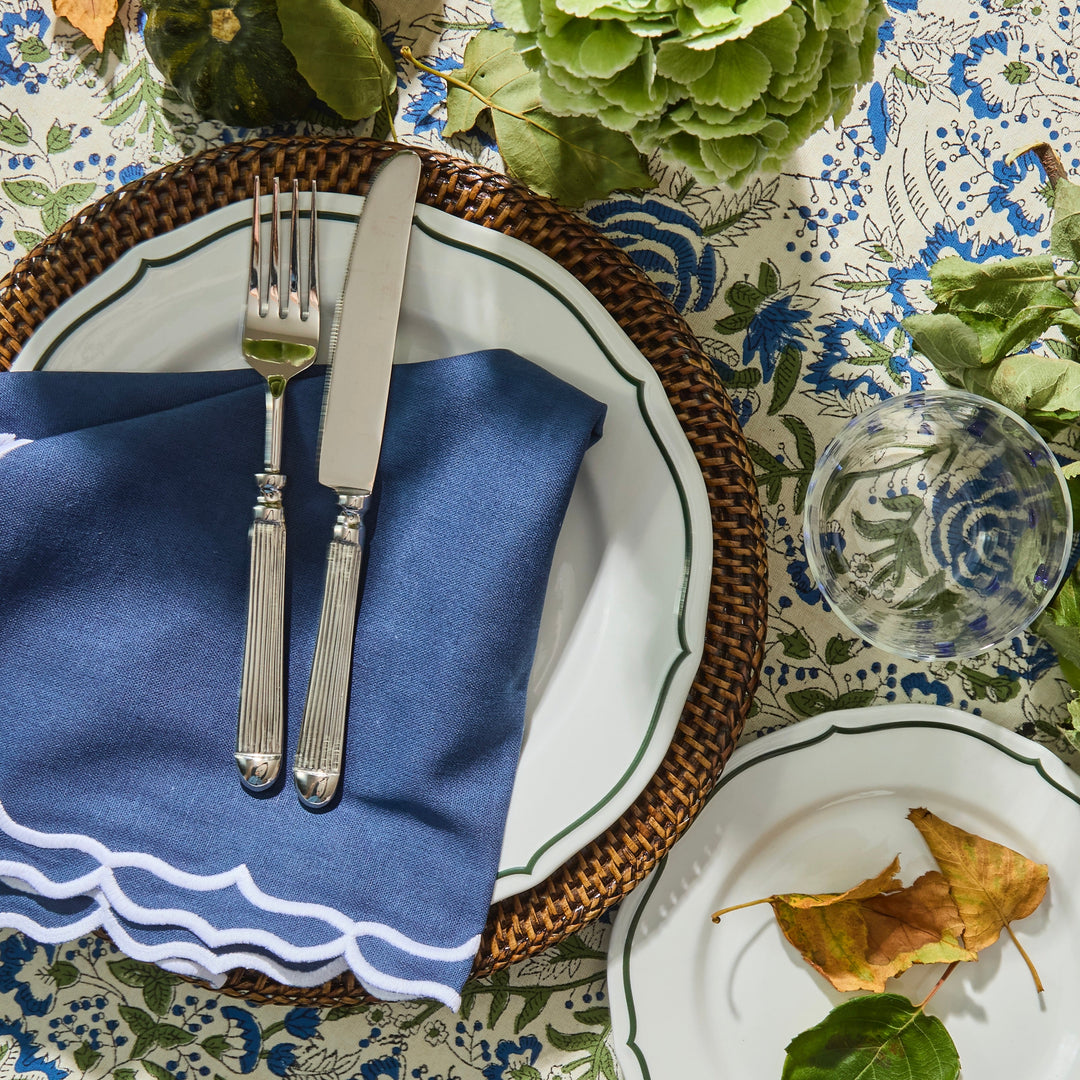 Blue Sasha napkin showing white embroidered scallop trim detail